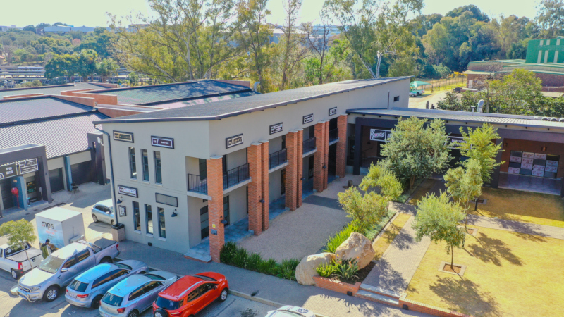 aerial view of innovation worx - 16th road showing the park, parking and a common area with trees