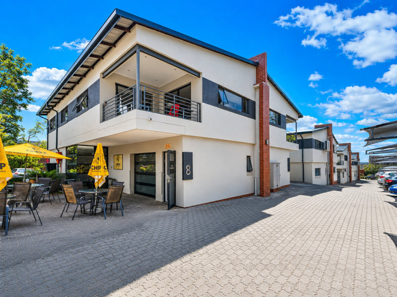 exterior view of commercial units and a seating area at innovation worx - business park