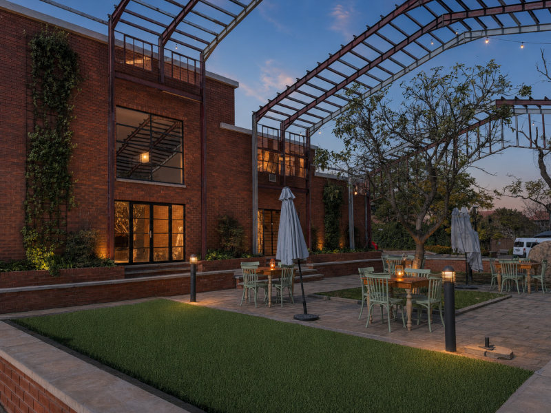 night view of the outdoor seating area with tables at innovation worx - richards drive