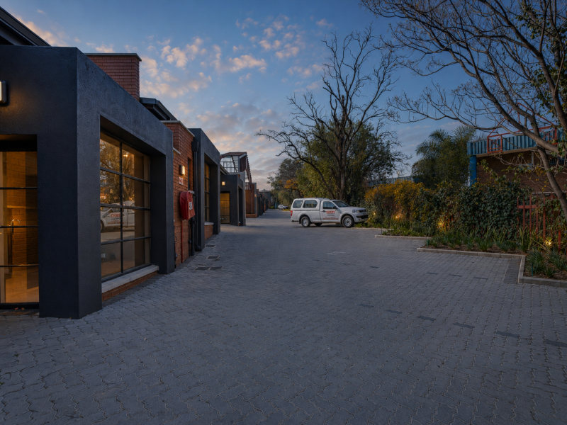exterior of innovation worx - richards drive showing units and on-site parking